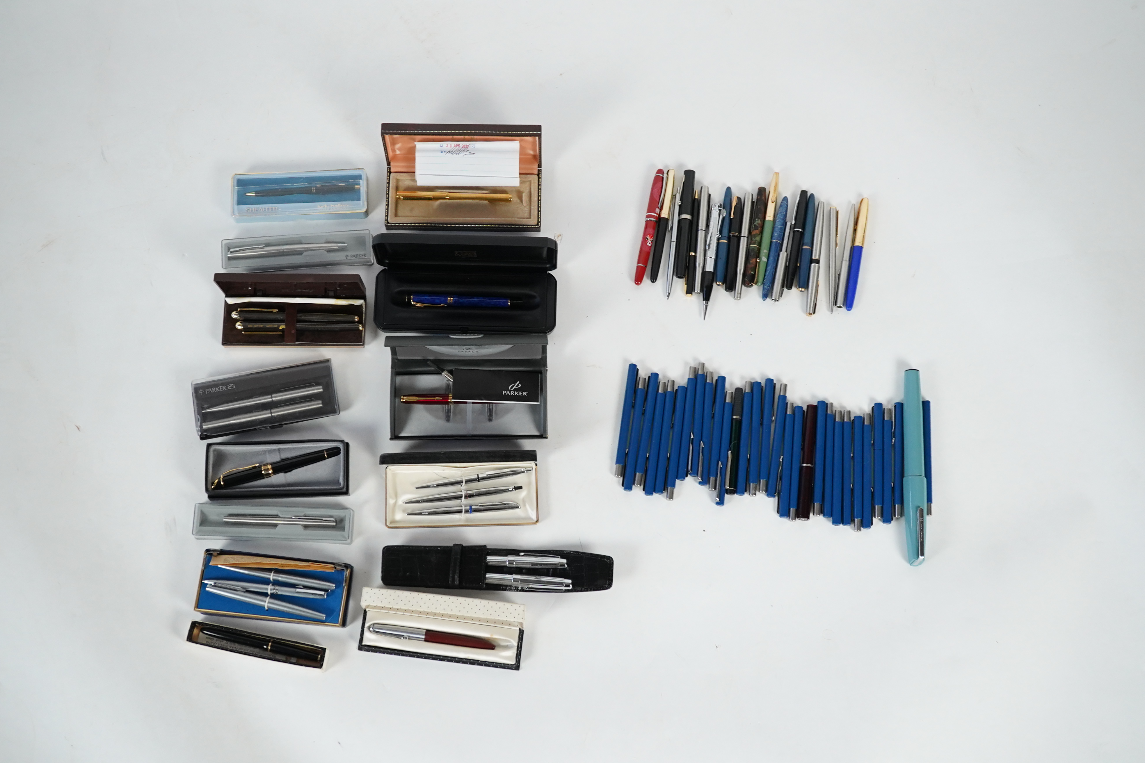 A cased Parker duofold ballpoint pen, a cased Parker Sonnet lacquer ruby red fountain pen, a Dunhill gold plated fountain pen and various fountain pens and ballpoint pens including Parker, Sheaffer, Quill, etc.